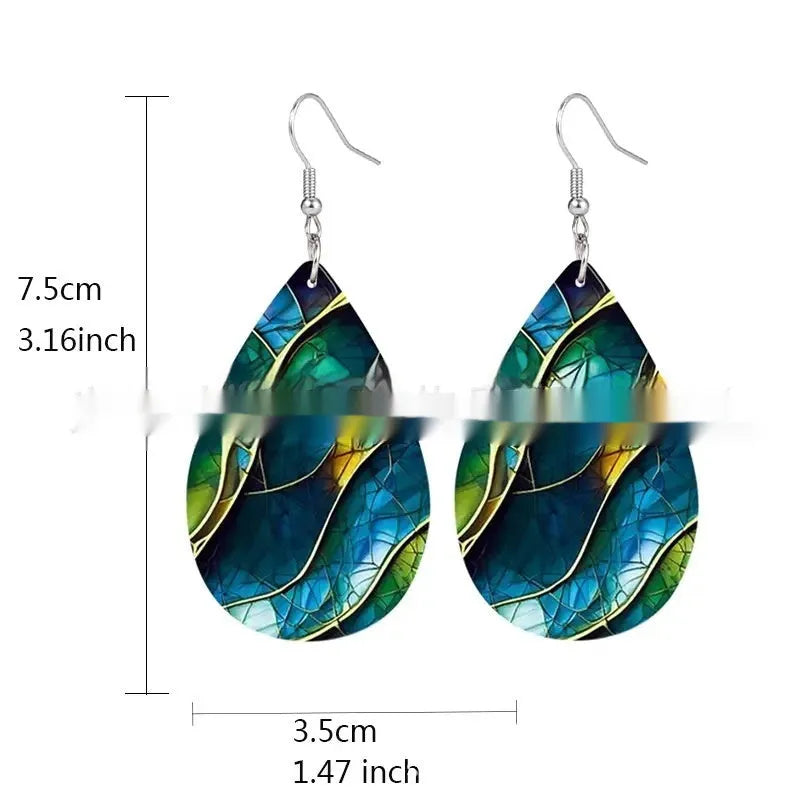 A pair of printed acrylic drop earrings with a flat branch knot design.