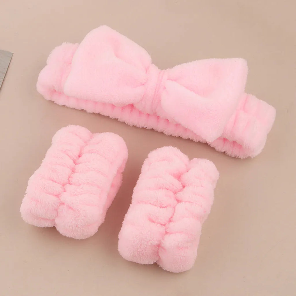 Facial brush and coral fleece hair band set in purple, grey, white, and pink colours.
