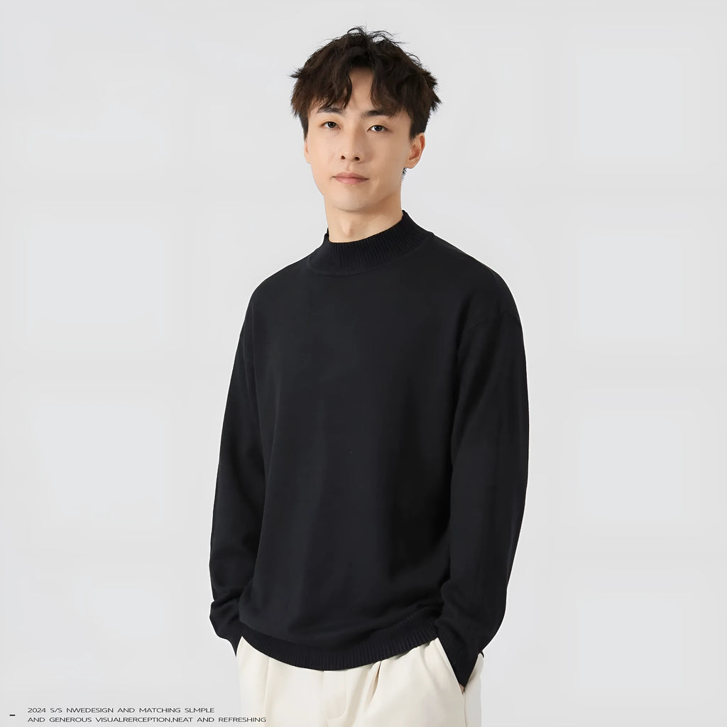 A man's loose-fitting, long-sleeve pullover sweater in a solid colour, showing a casual relaxed fit.