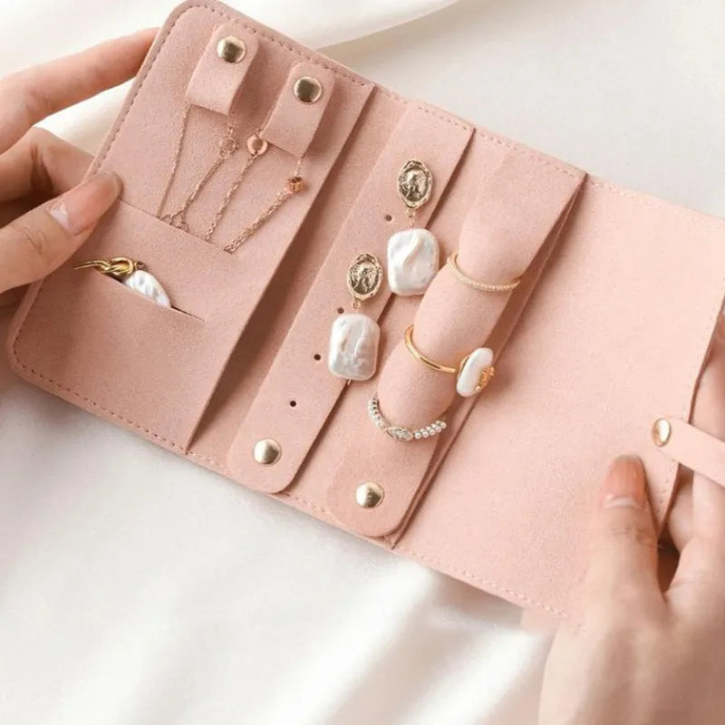 Brown soft leather and microfiber jewellery storage pouch measuring 12 by 12 centimetres.
