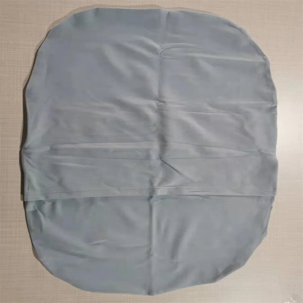 Cotton portable baby nest crib for newborns, beige colour, shown on a bed.