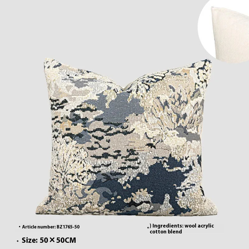 Antique blue wool-blended square throw pillow with abstract floral pattern on a neutral sofa