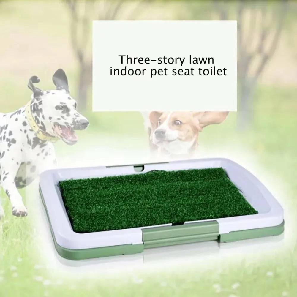 Green artificial grass indoor dog toilet tray with drainage holes and absorbent pads for puppy training.