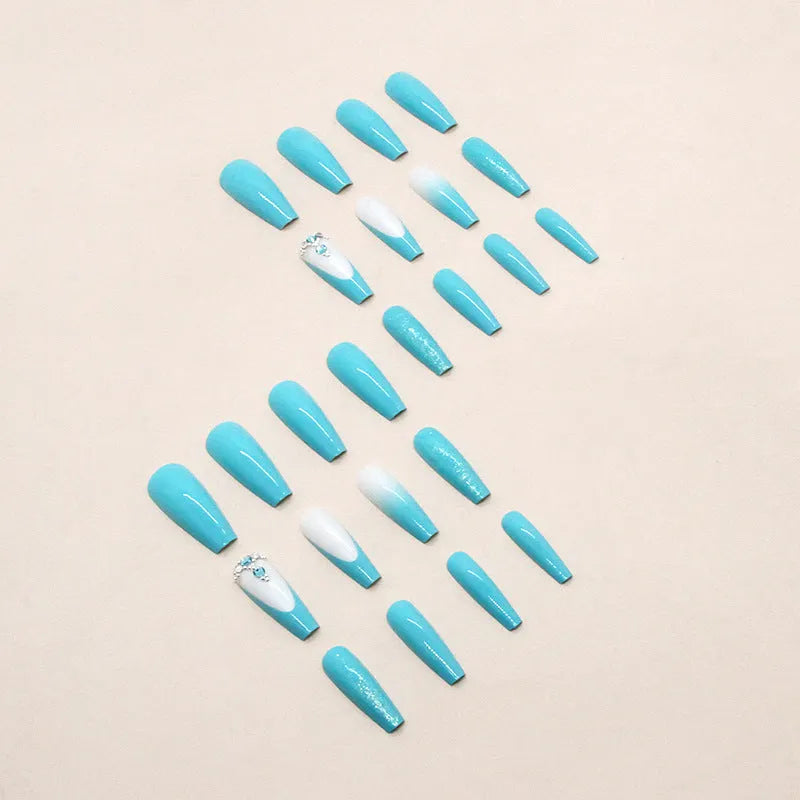 Solid blue long ballet false nails with diamond glitter design and included adhesive glue.