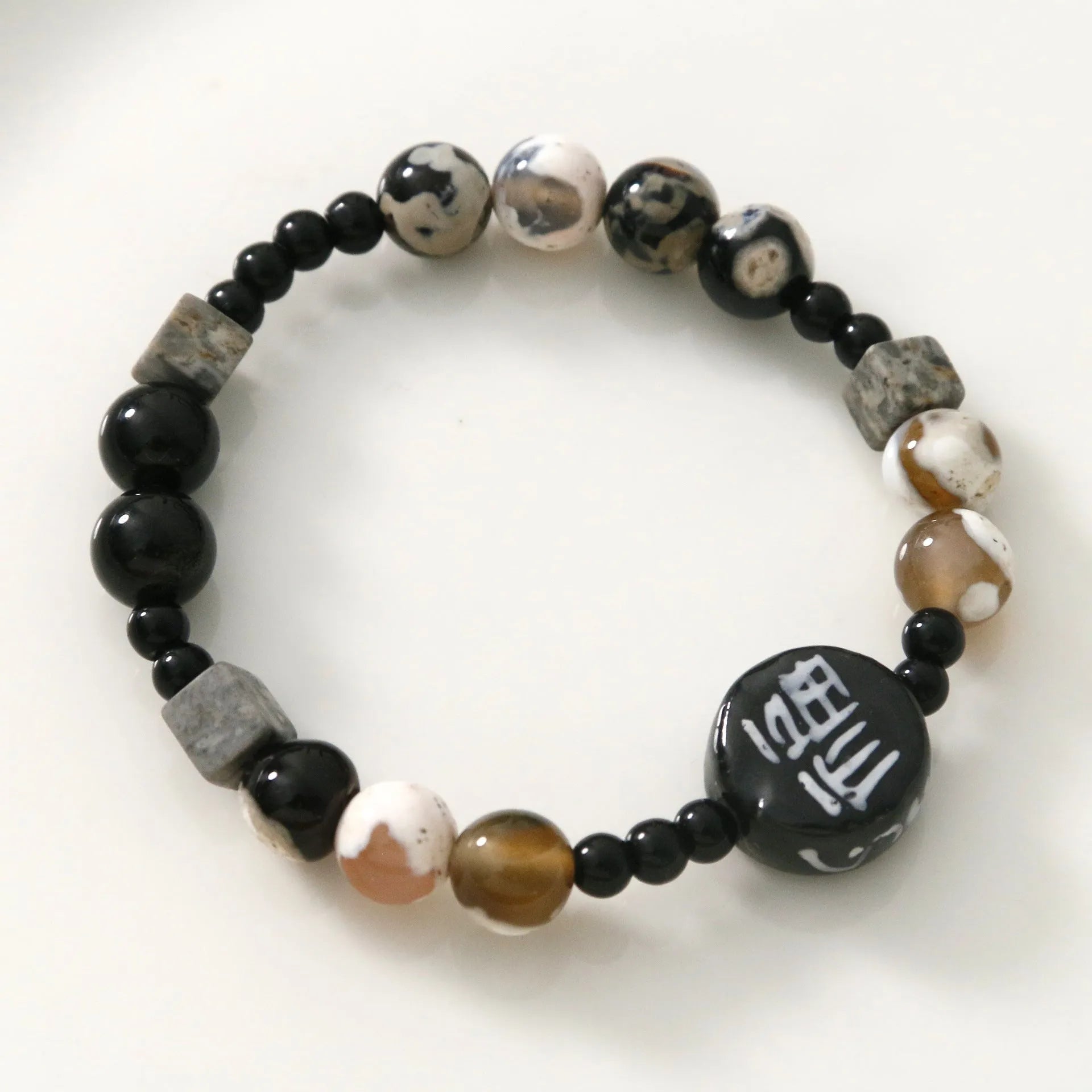 Hand-woven natural black agate and ceramic bracelet with geometric round bead design