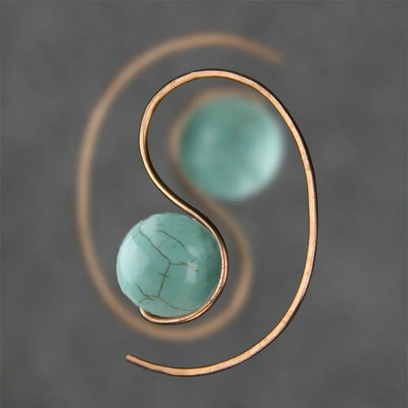 Green turquoise retro style dangle earrings with blue turquoise centrepiece on a white background