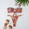 Women's floral print bikini set with halter neck tube top and briefs on a mannequin.