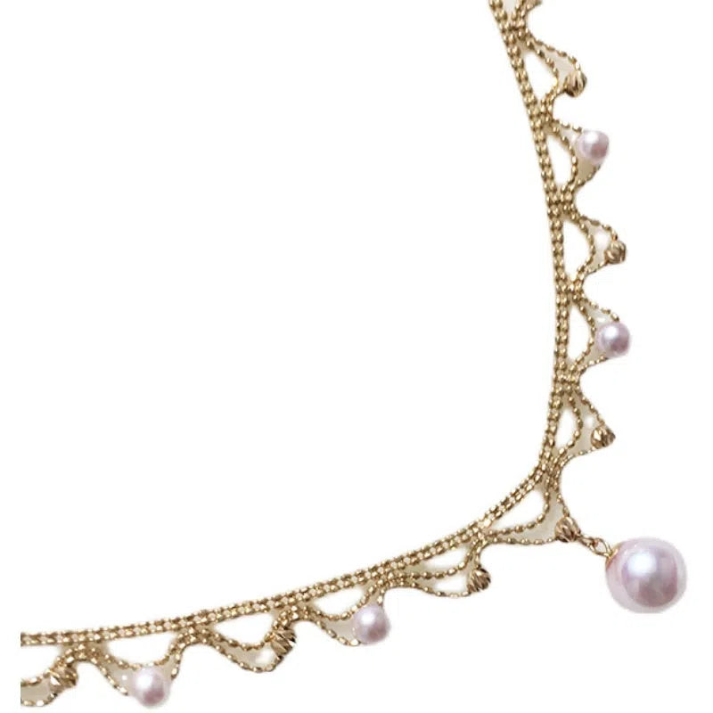 Aurora Japanese 18k gold lace pearl necklace with round sea pearl and gold finish on display