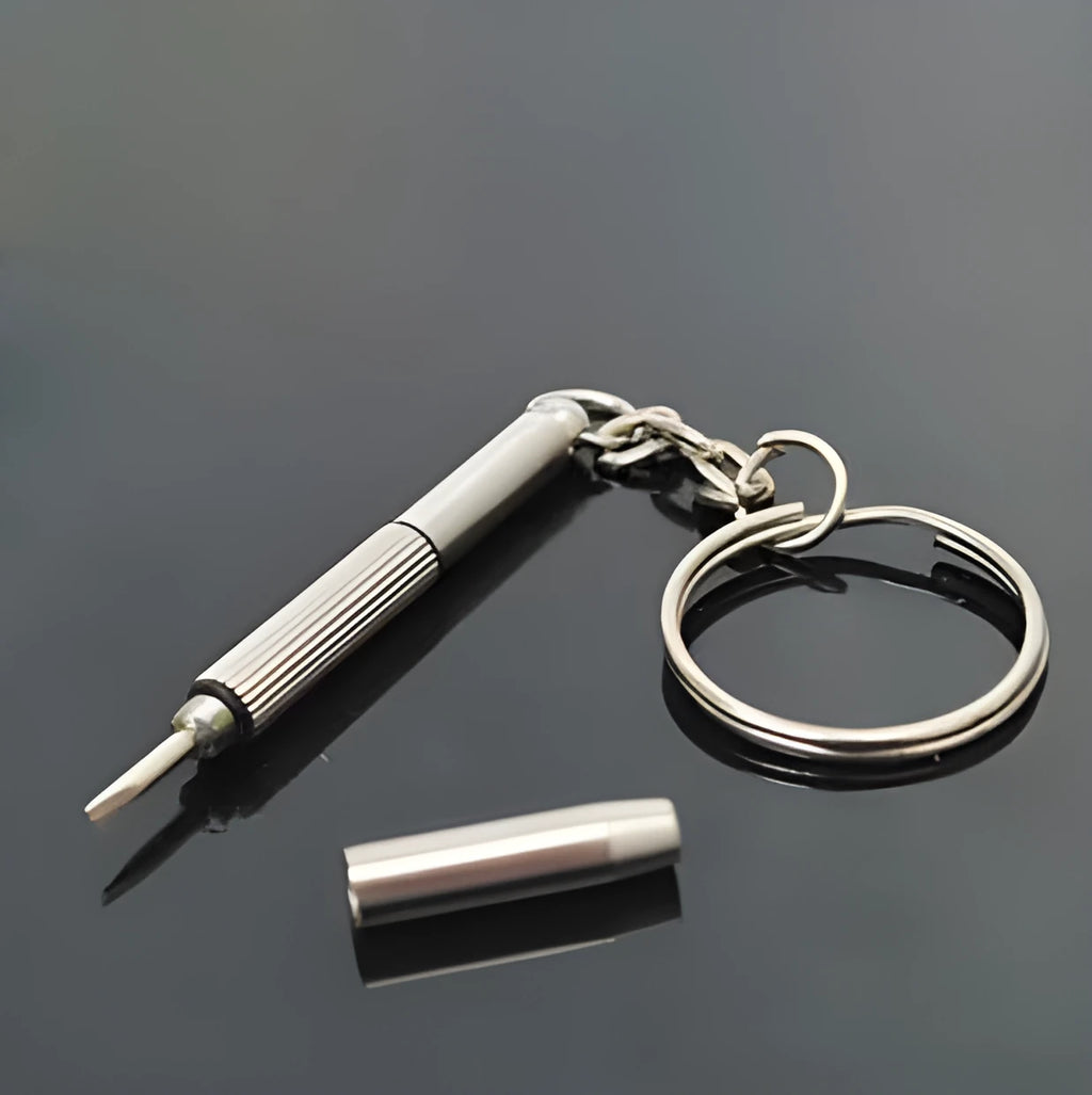 Stainless steel three-purpose screwdriver tool for glasses repair on a clean surface
