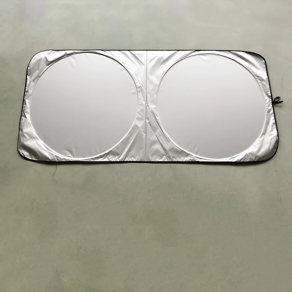 Silver tape car sunshade in 190x90cm size laid against a car windshield