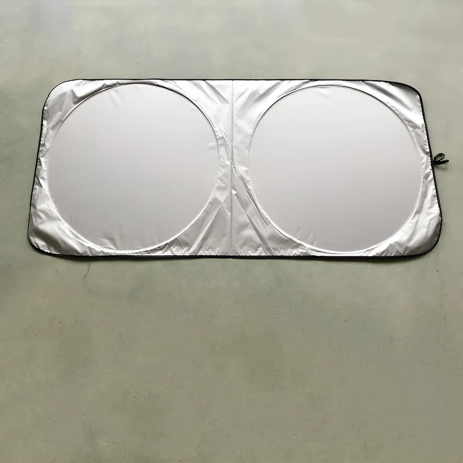 Silver tape car sunshade in 190x90cm size laid against a car windshield