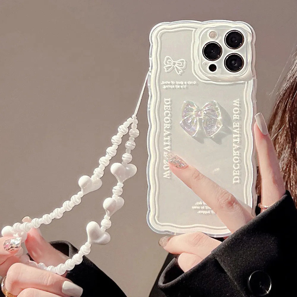 Clear transparent iPhone case with a raised ice-blue bow decoration on the back