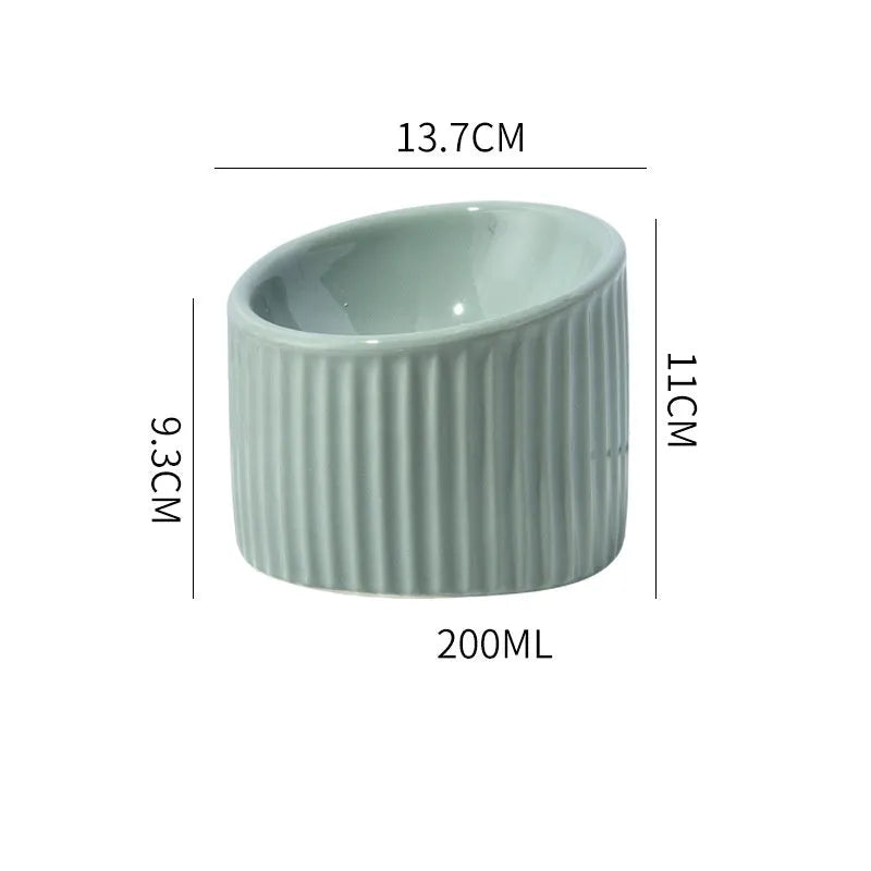 Ceramic elevated cat bowl in green colour with tilted round design for comfortable feeding.
