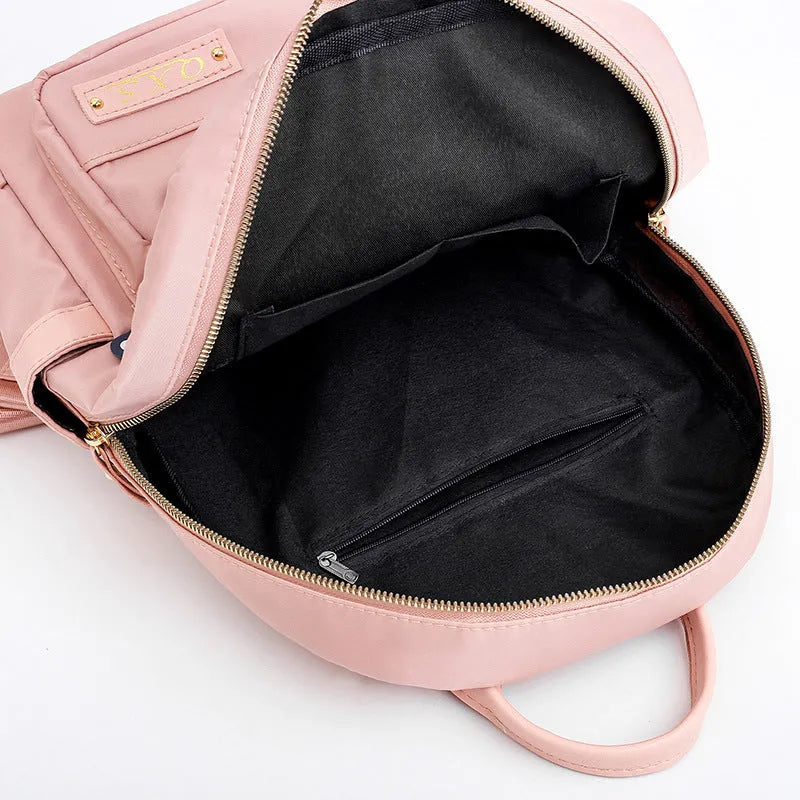 Black nylon casual backpack with square vertical shape, soft handle, and three-dimensional outer pocket