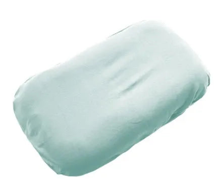 Cotton portable baby nest crib for newborns, beige colour, shown on a bed.