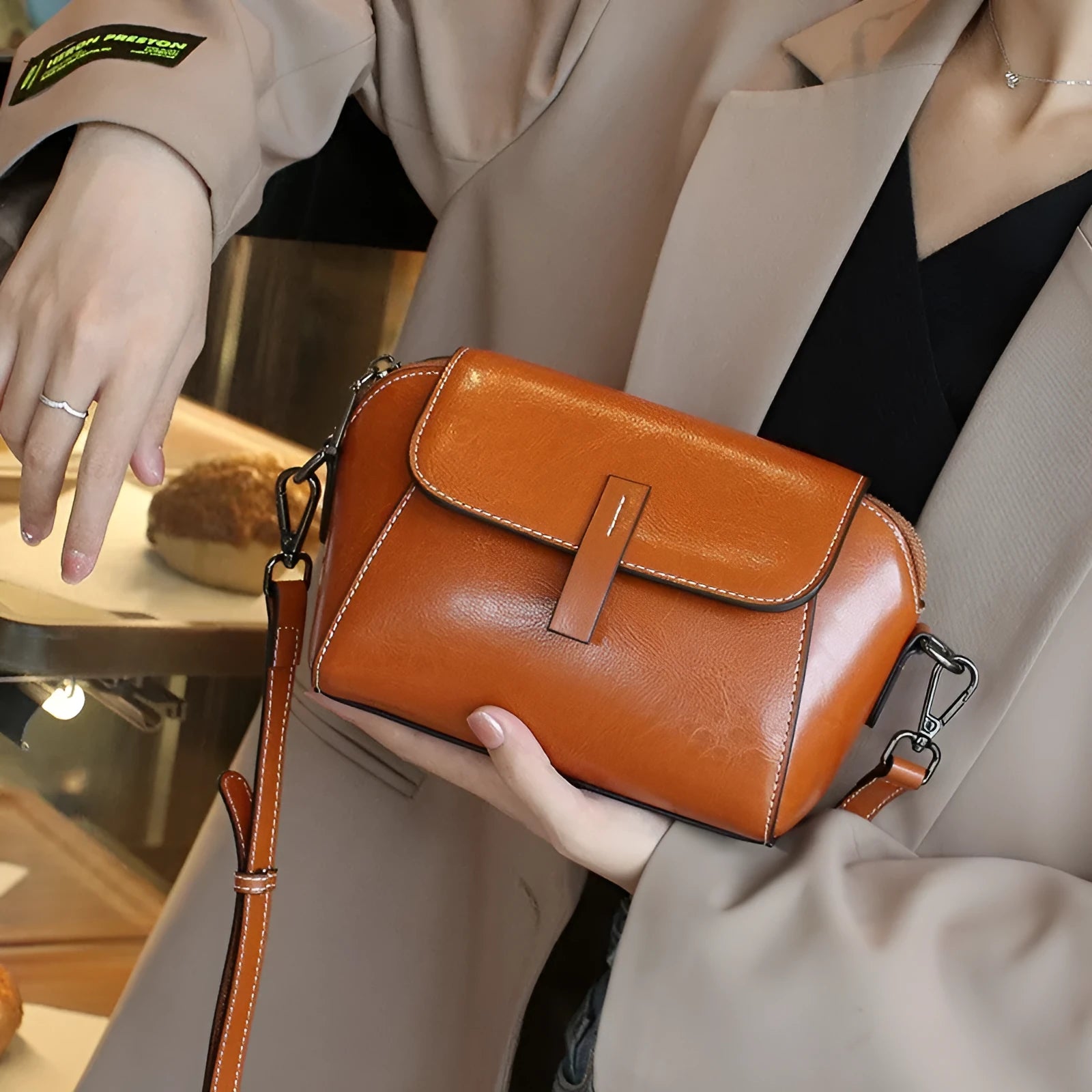 Brown oil wax leather women's messenger bag with cross-body strap showing shell shape and interior compartments
