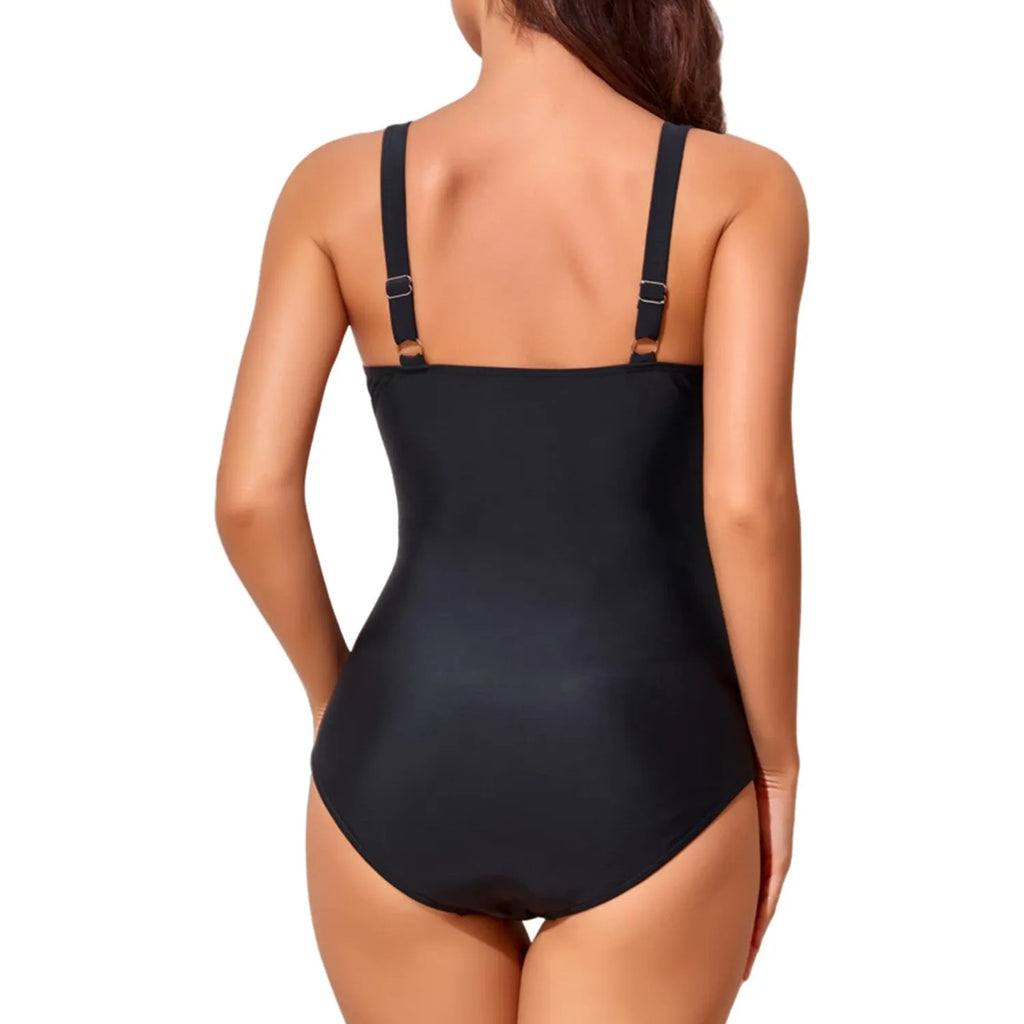 Black one-piece swimsuit on a model showing deep V-neck cross front with pleated detail.