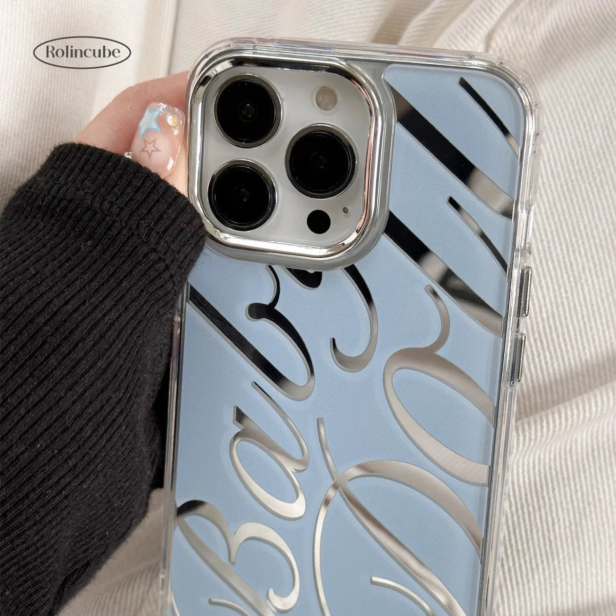 Blue transparent iPhone case with mirror finish showing English letters on back