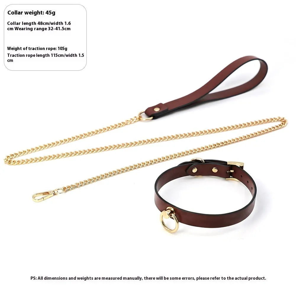 Genuine cowhide leather collar with metal fittings and a connected pull lead on a dark surface.