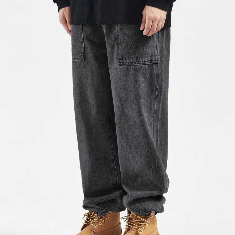 Mens loose straight vintage wide leg jeans in washed black denim, front view