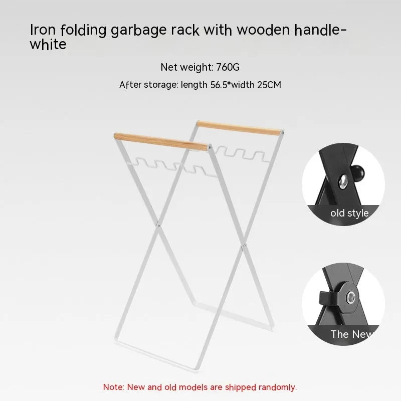 Black iron folding trash storage rack with a wooden handle for hanging bin bags.