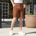 Man wearing loose-fit beige mid-length casual trousers with an elasticated waistband.
