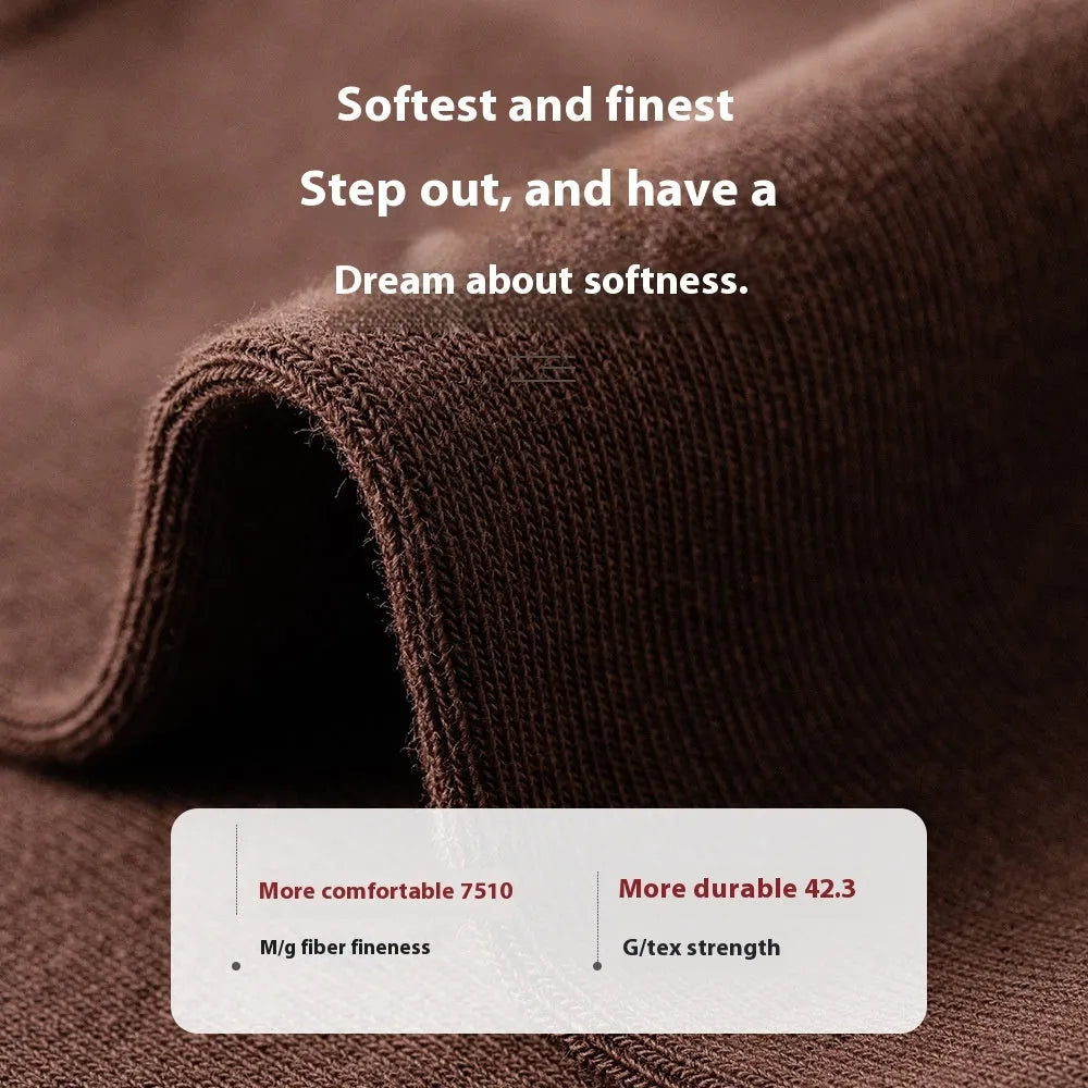 Five pairs of men's solid colour mid-calf socks made from combed cotton, shown in assorted shades.