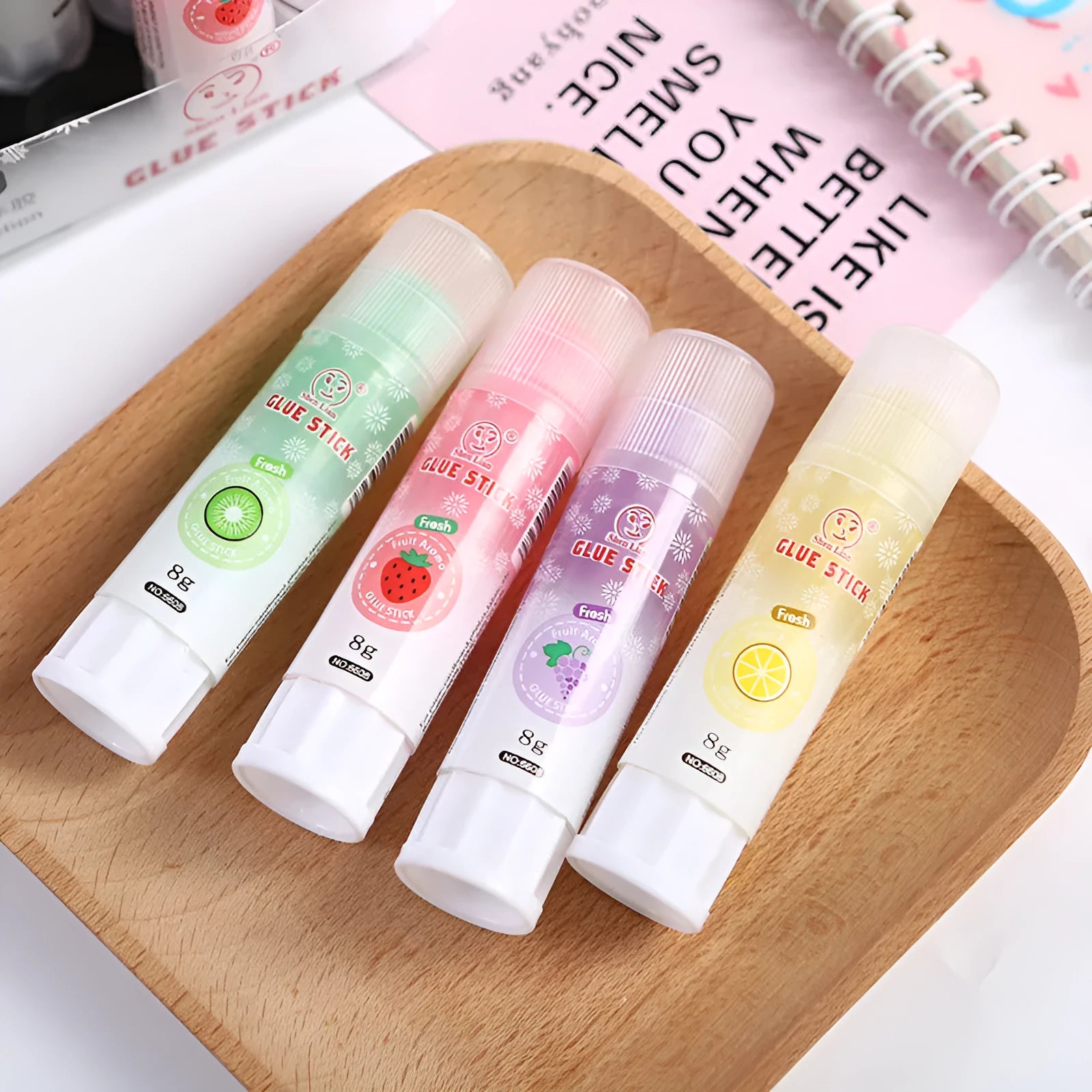 Two fruit-printed jelly solid glue sticks showing random colours and compact 8.5 cm size