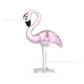 Pink crystal flamingo figurine on a modern hall table as a decorative animal craft prop