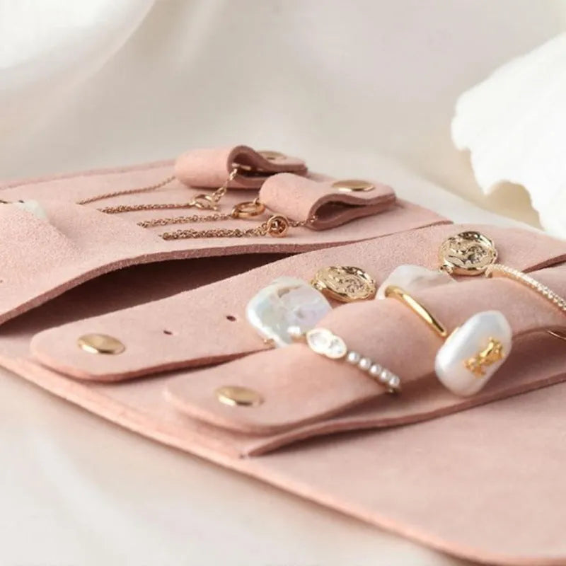 Brown soft leather and microfiber jewellery storage pouch measuring 12 by 12 centimetres.