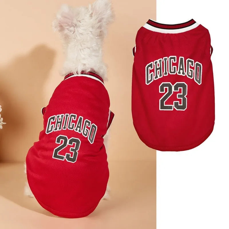 Dog wearing a black mesh polyester basketball vest with number 23 print, side view