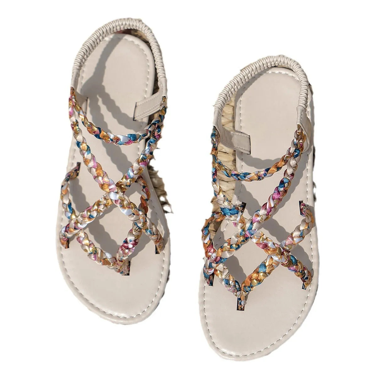Pair of adult flat sandals with elastic band fastening, cloth upper, and round toe in white.