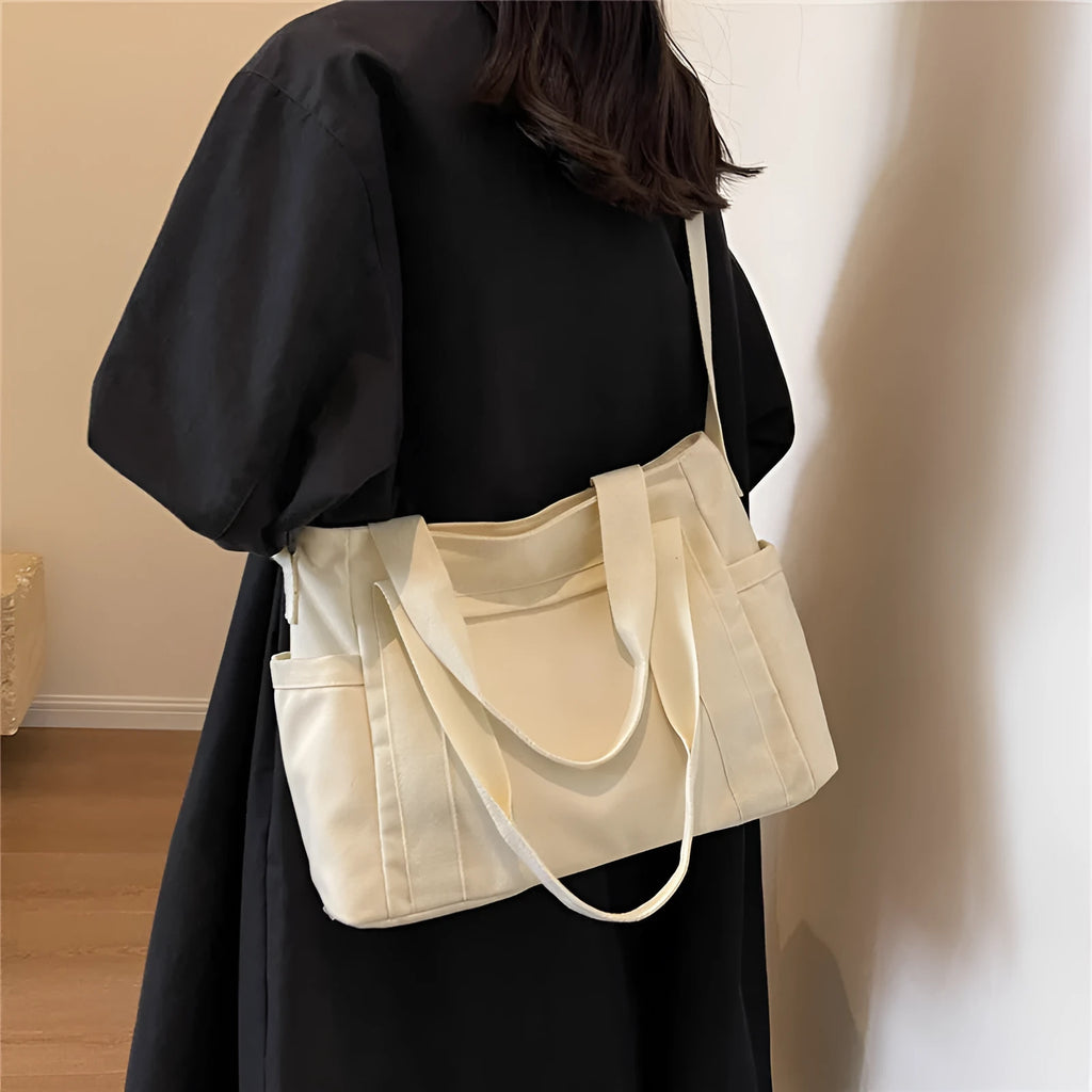 Large capacity polyester canvas shoulder tote bag in a solid colour, showing outer sandwich pocket.