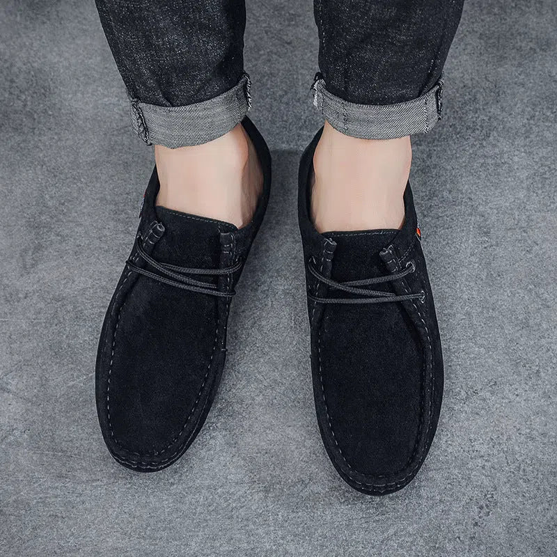 Men's black slip-on loafers with soft sole, round toe, and stitching detail on a neutral background