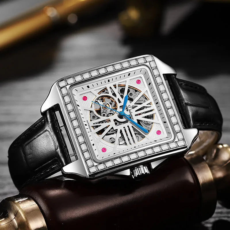 Men's square stainless steel automatic watch with diamond bezel on a black leather strap.