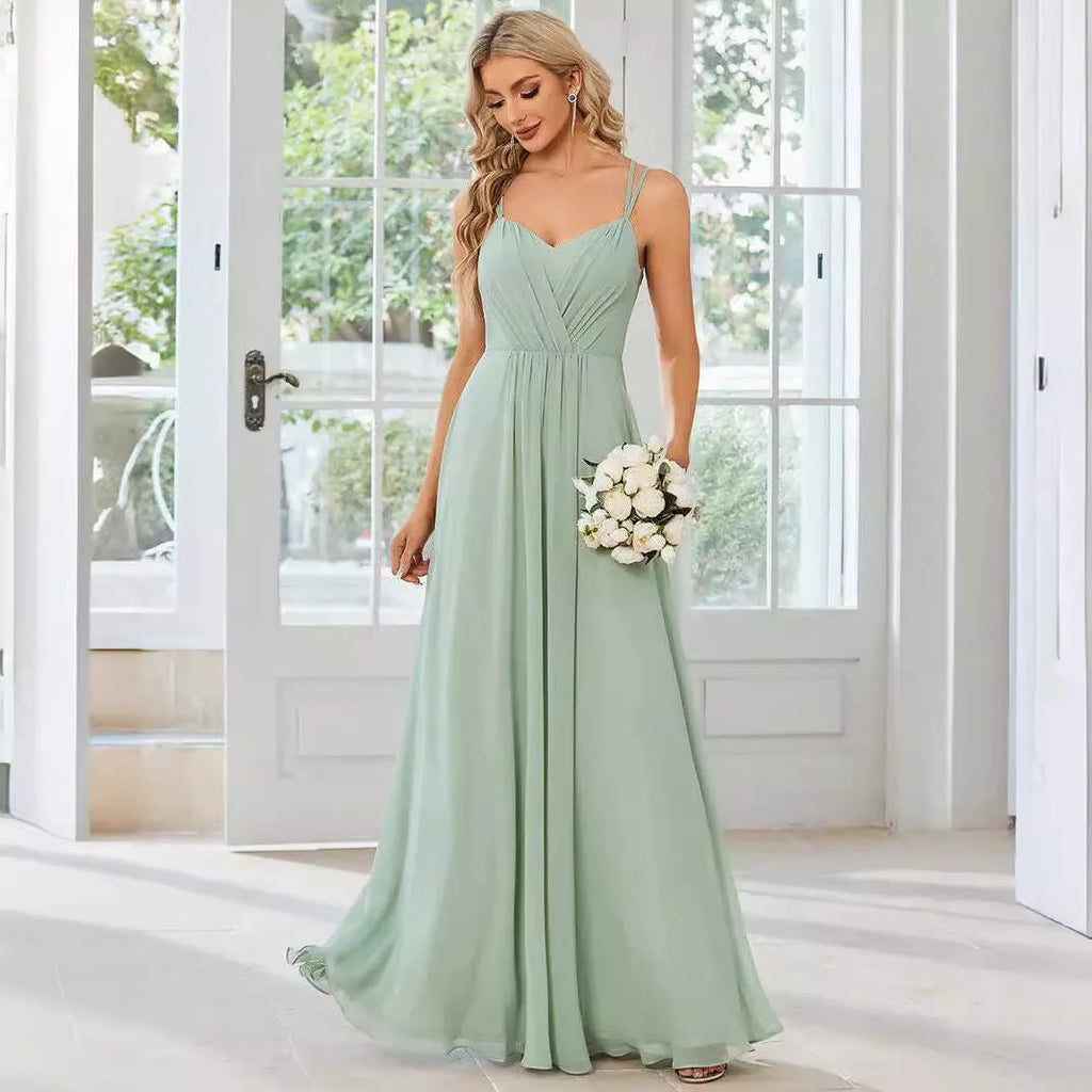 Women's sleeveless banquet dress with pleated A-line long skirt in light green, showing sling neckline.