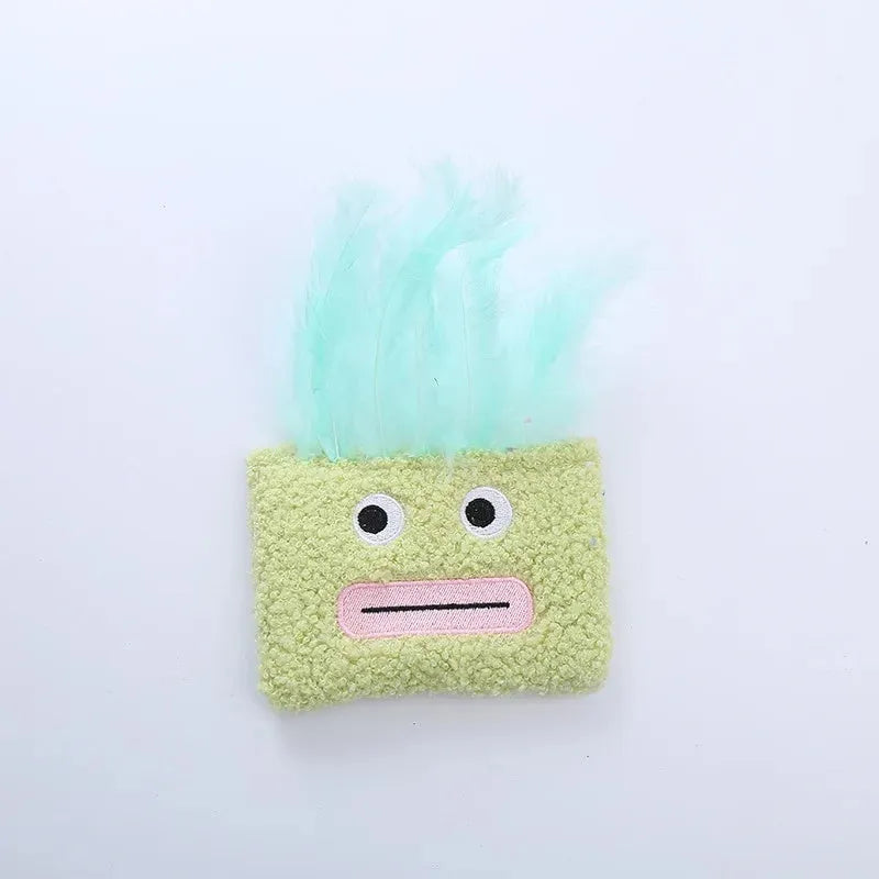 Colourful catnip plush toy with a funny big mouth explosion head shape on a blue background.