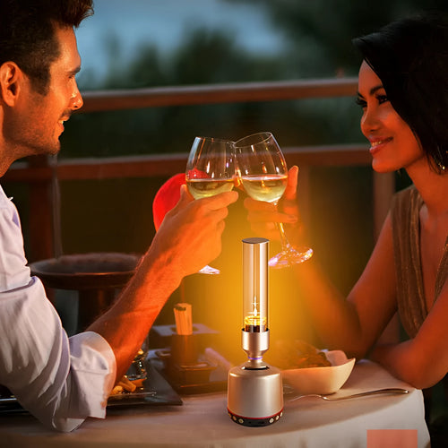 White silver candlelight Bluetooth speaker and night light on a table.