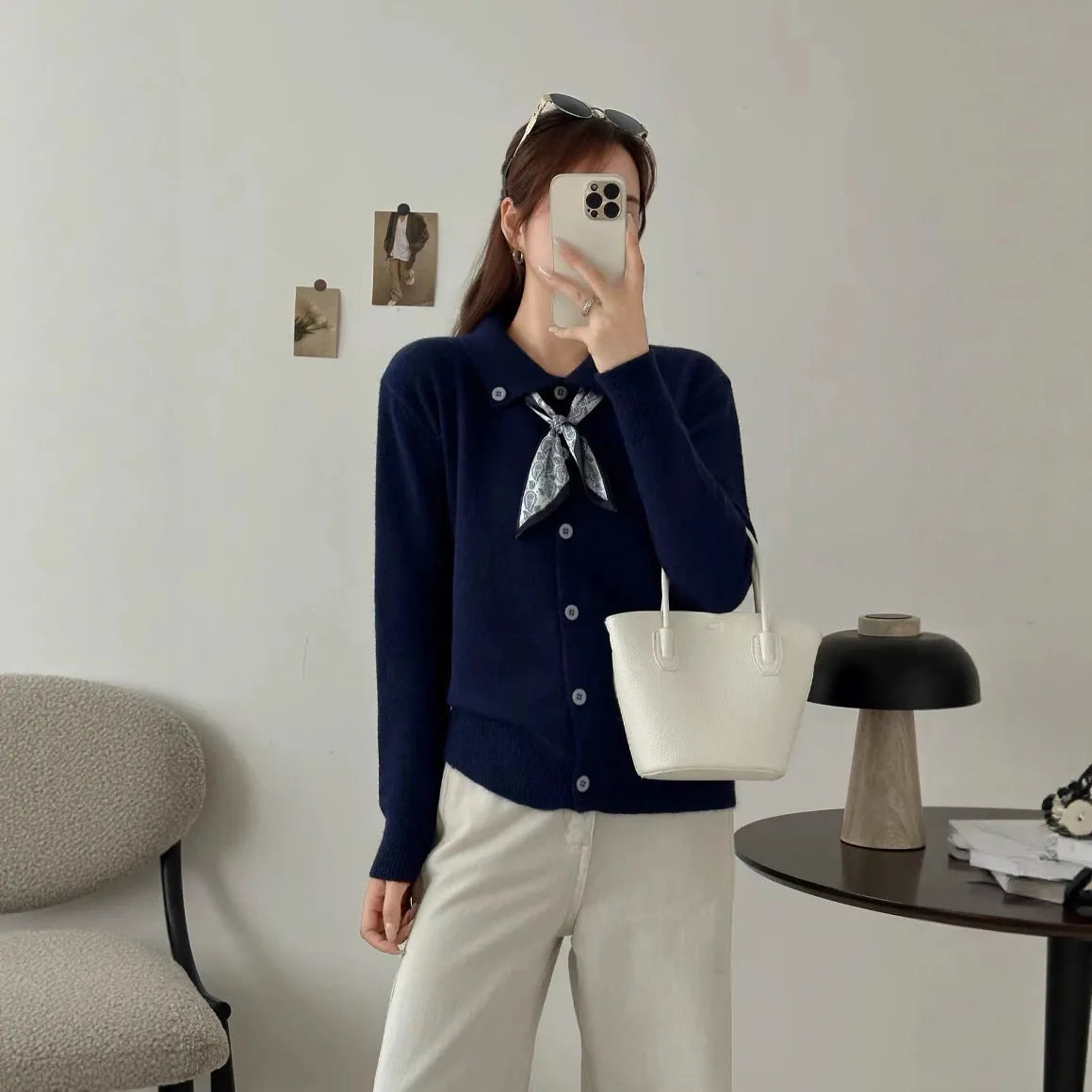 Milky white acrylic fibre cardigan sweater with a lapel scarf and long sleeves laid flat