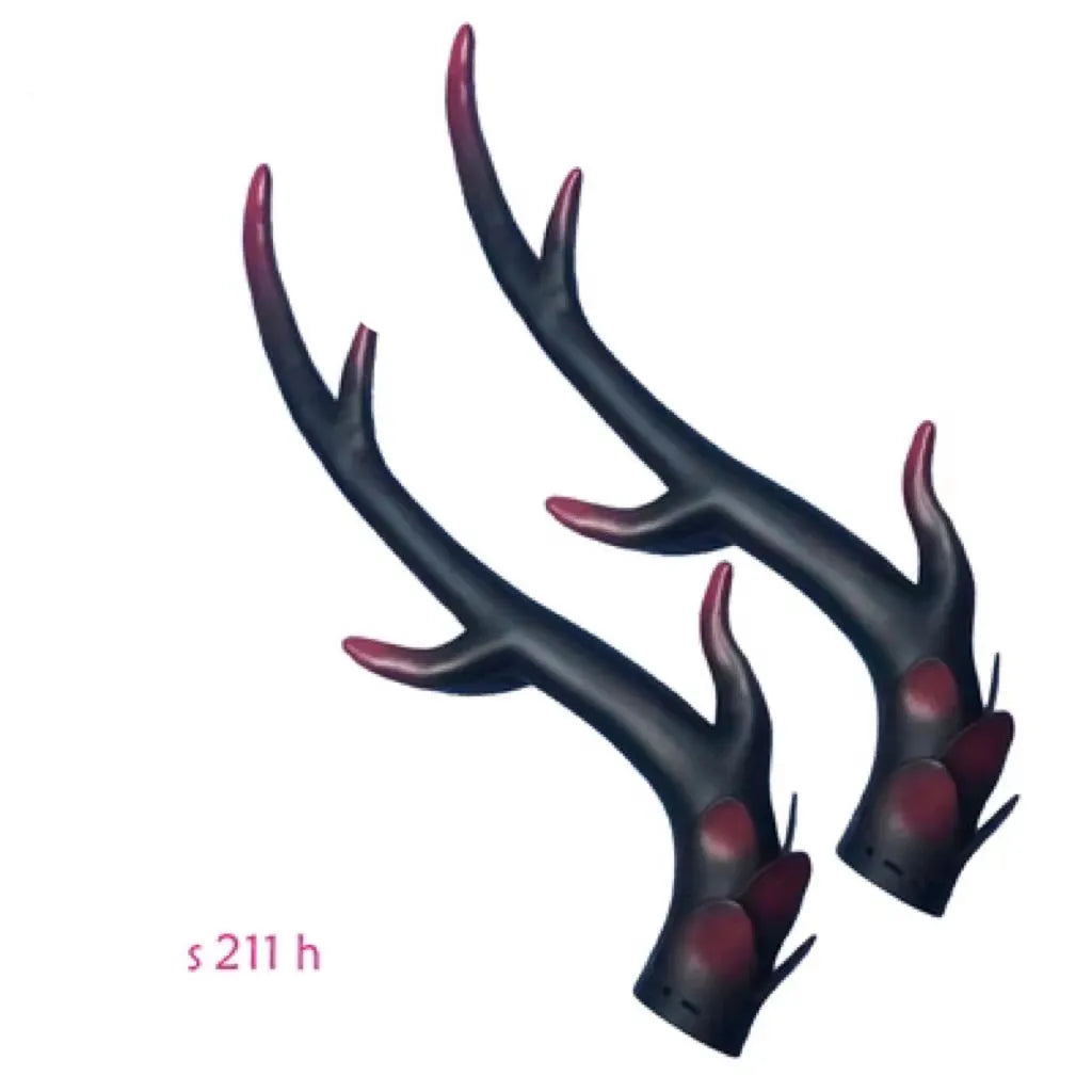 A pair of resin dragon horn decorations for motorcycle helmets in black, shown next to a ruler for scale.