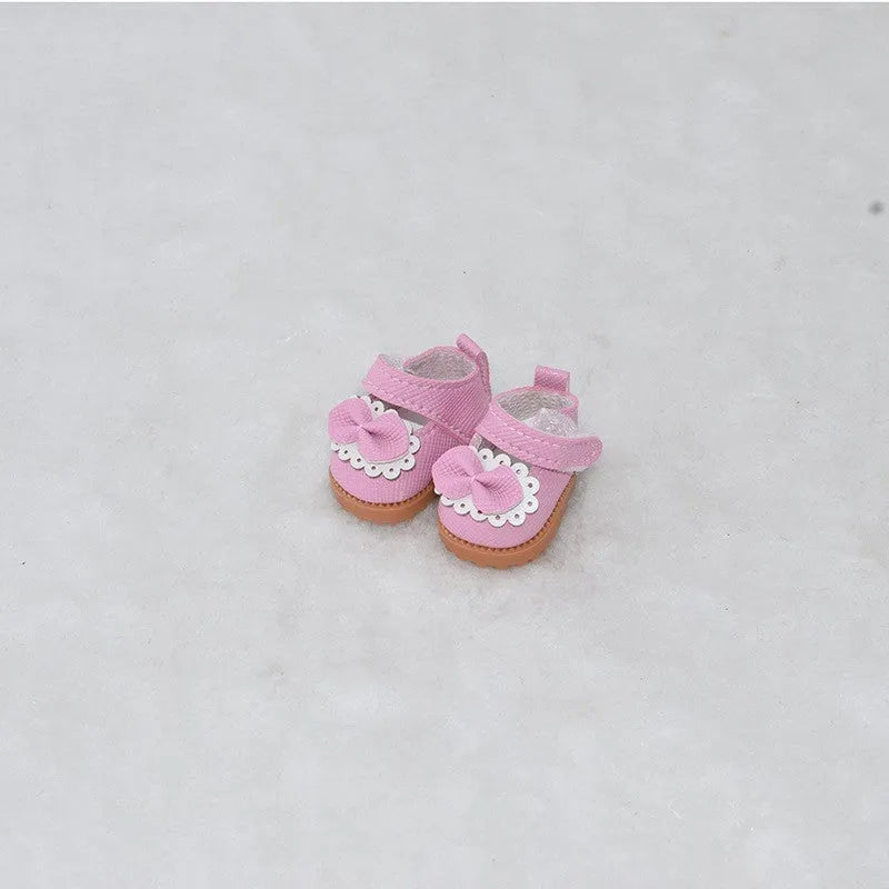 A pair of 17cm scale PU doll shoes in a selected colour and style, such as black leather shoes or brown boots.