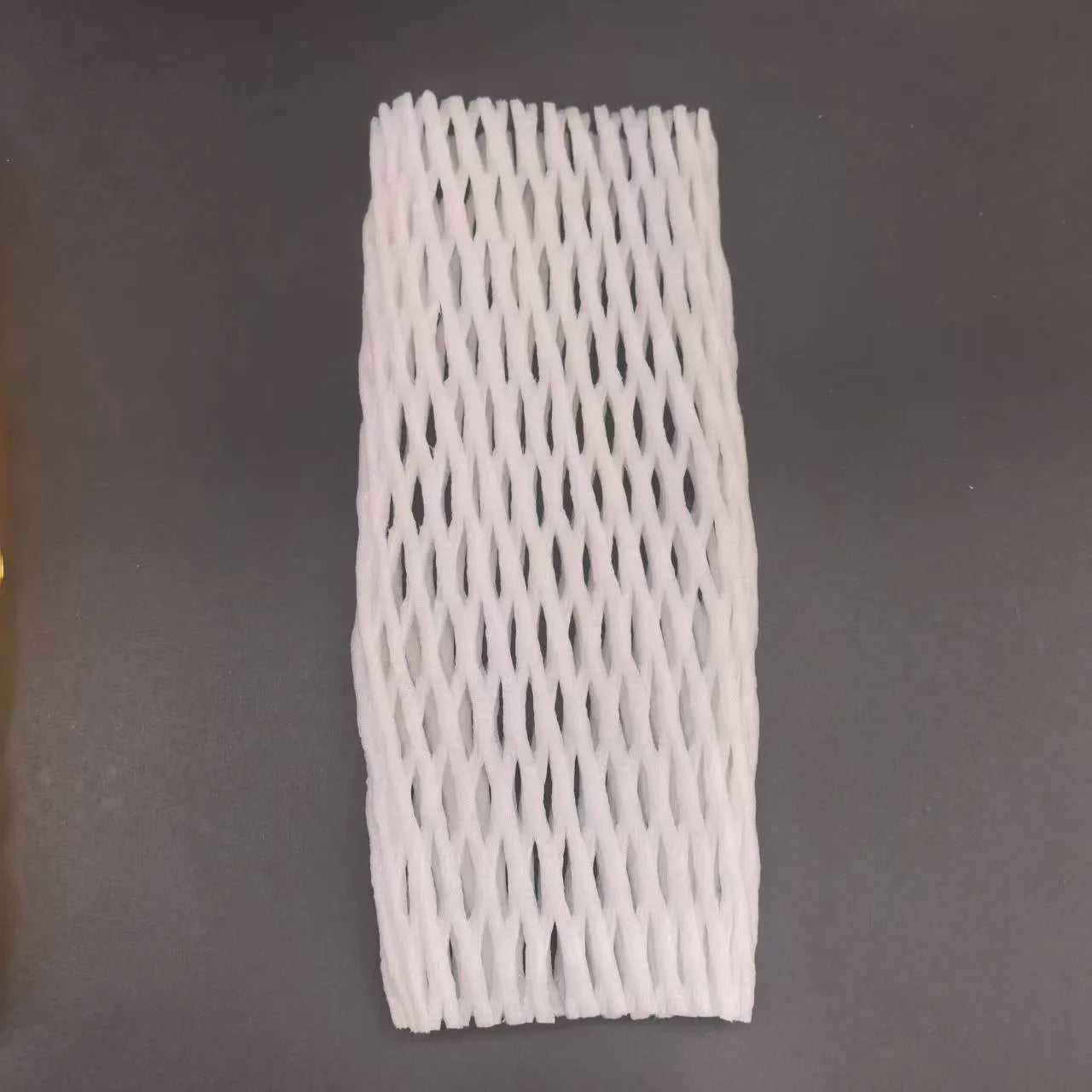 White foam protective net cover for apples, pears, peaches and oranges.