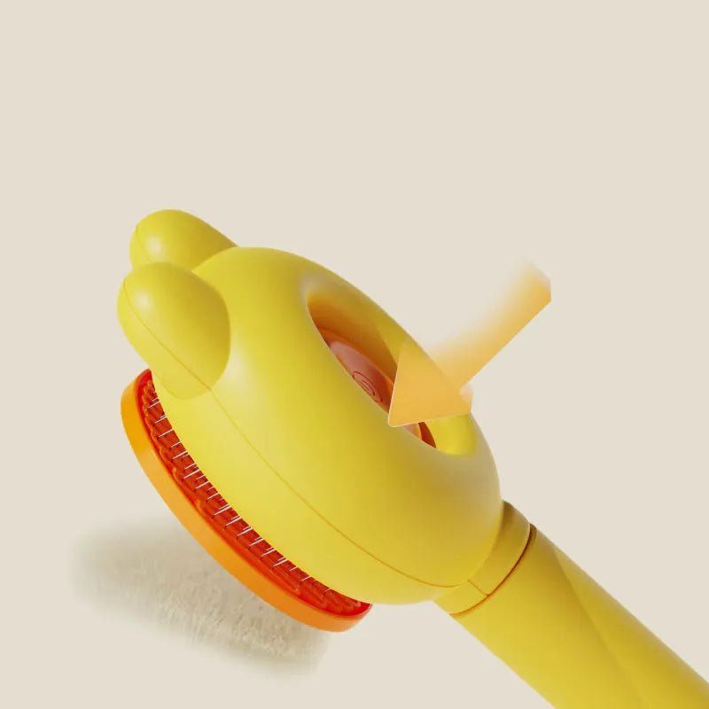 Green self-cleaning pet brush with a metal comb, release button, and comfort-grip handle for grooming cats and dogs.