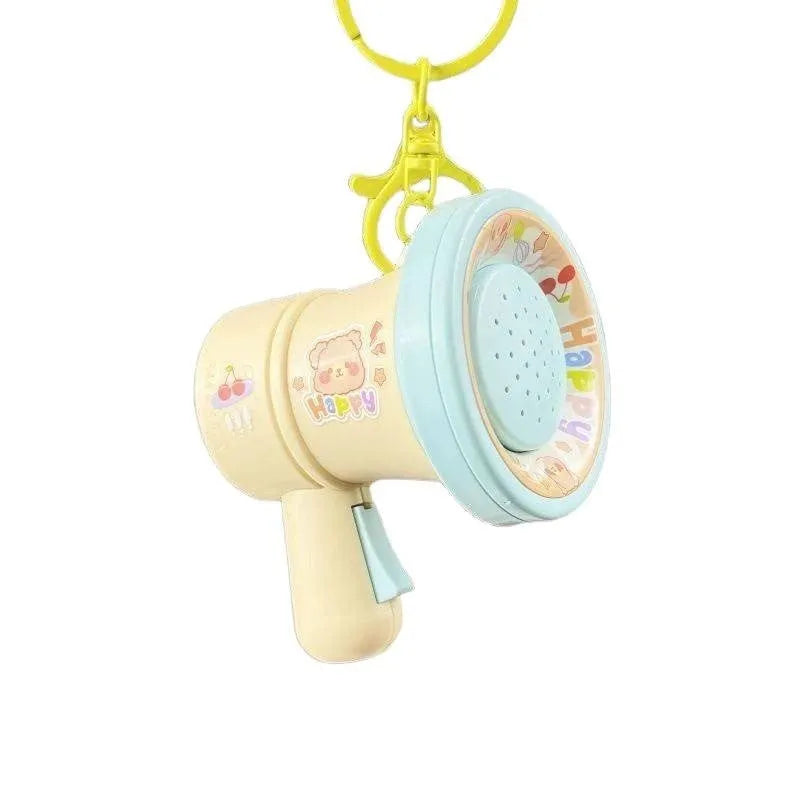 Green or yellow plastic cartoon horn keychain ornament on plastic key ring