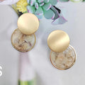 Round matte resin female earrings with retro design and smooth surface for casual wear.