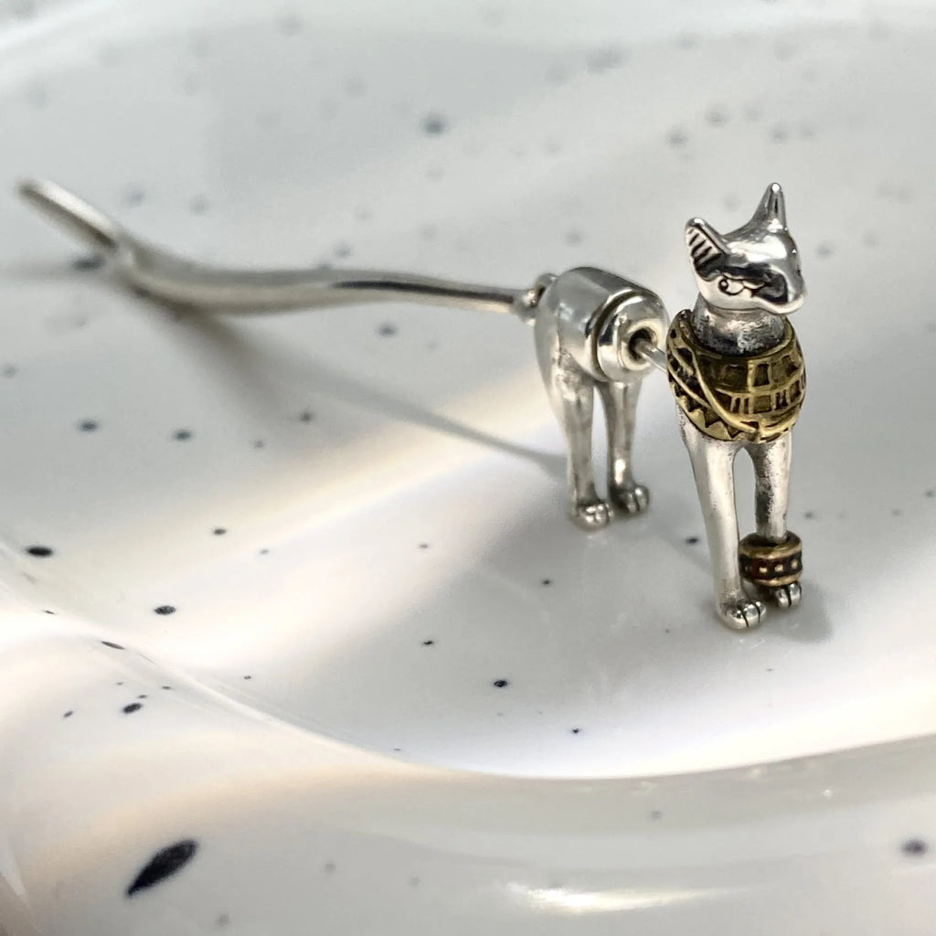 Single copper earring with pharaoh cat shape, gold and silver two-tone copper plated finish, colour separation design