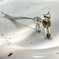 Single copper earring with pharaoh cat shape, gold and silver two-tone copper plated finish, colour separation design