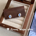 S925 sterling silver oval earrings with blue diamond heart-wrapped geometric design
