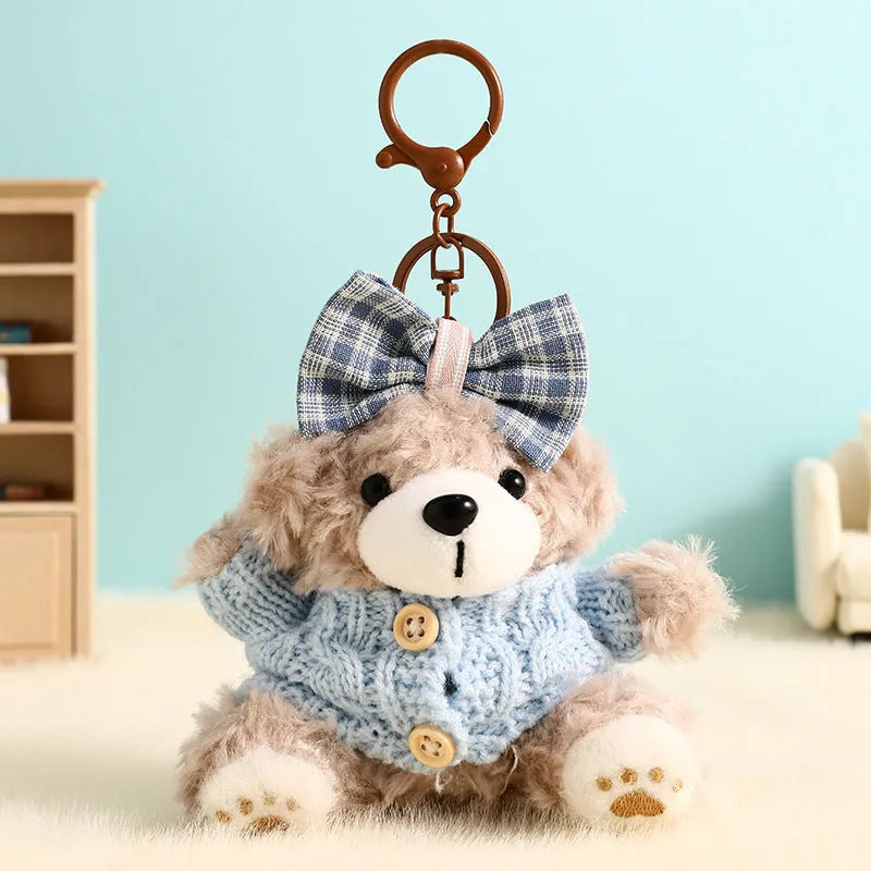 Plush biscuit bear keychain pendant with a red bow on a metal keyring