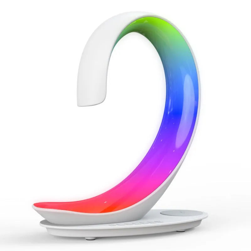 Multi-functional white swan desktop light with wireless charger, Bluetooth speaker, and colourful atmosphere light on a desk